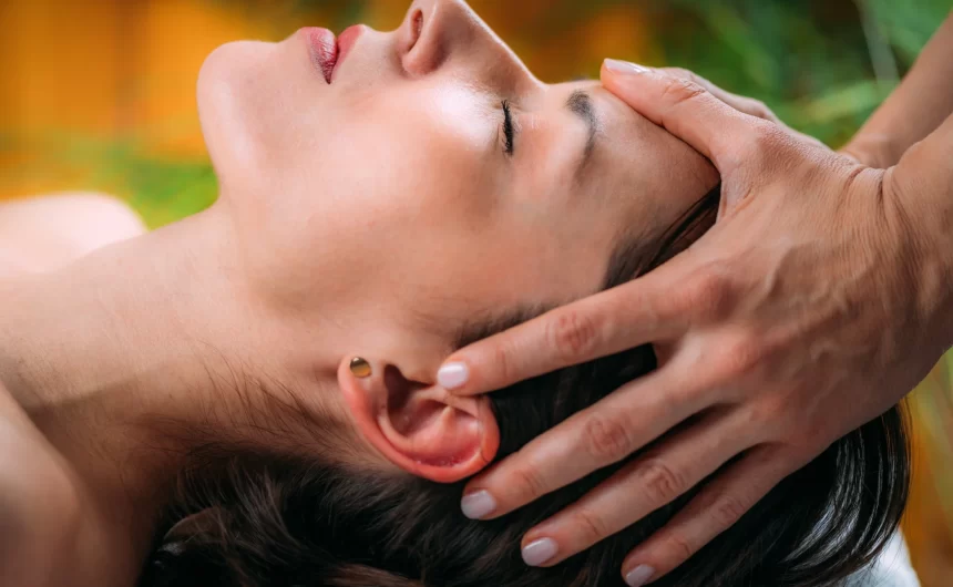 Close-up of woman receiving gentle scalp massage during a calming wellness spa treatment session