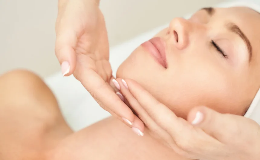 Close-up of a woman receiving a gentle facial massage during a relaxing professional spa treatment session.