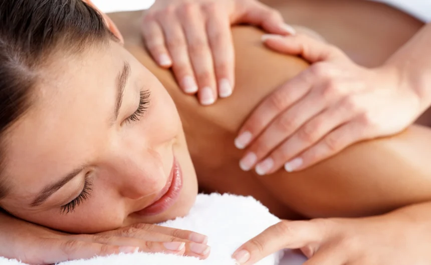Close-up of a woman receiving a relaxing shoulder and upper back massage during calming spa session.